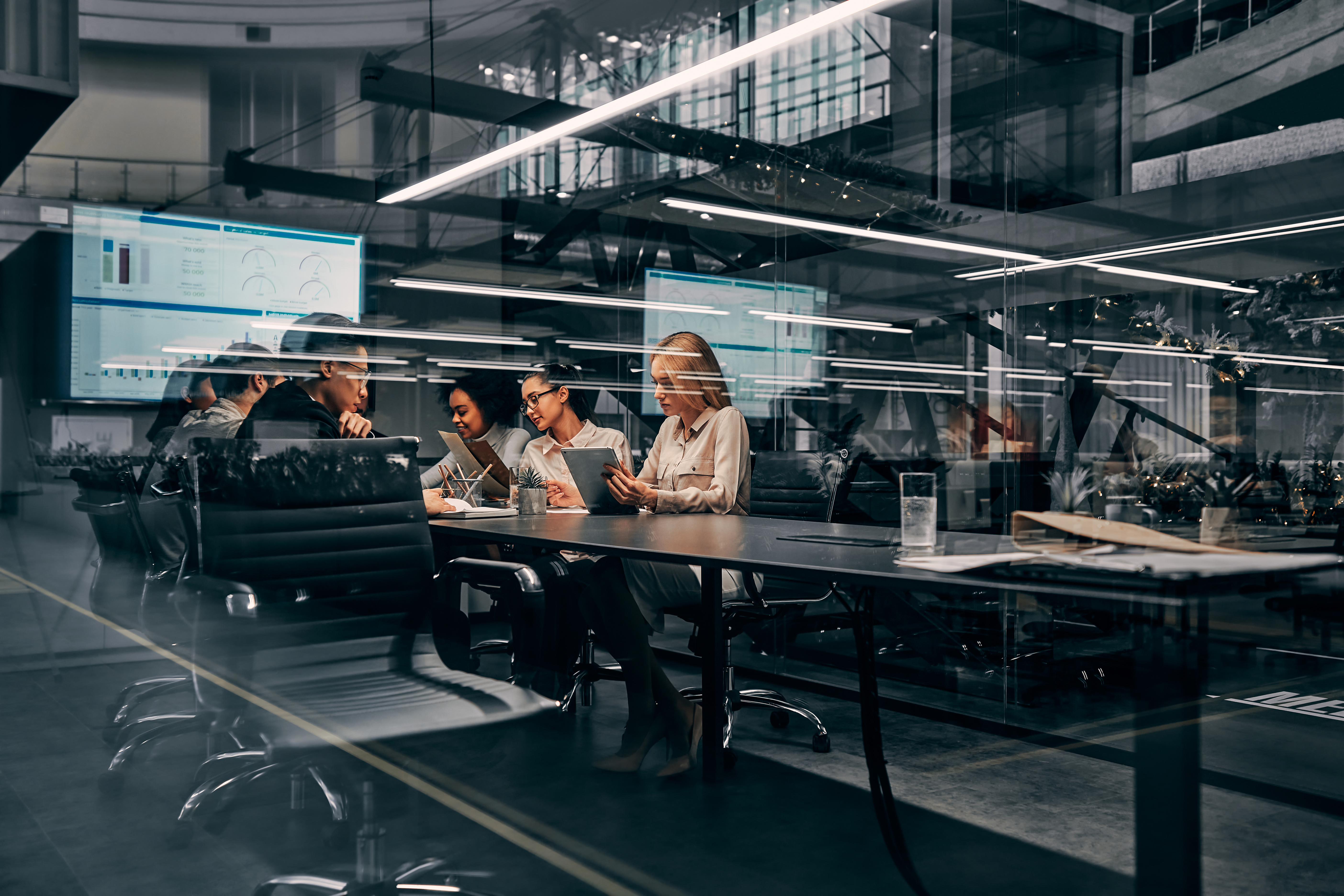 Modern Business Young Focused Serious Business Women And Men Working In A Conference Room Working On A Project Presentation Light From A Spacious Office Is Reflected Through The Glass